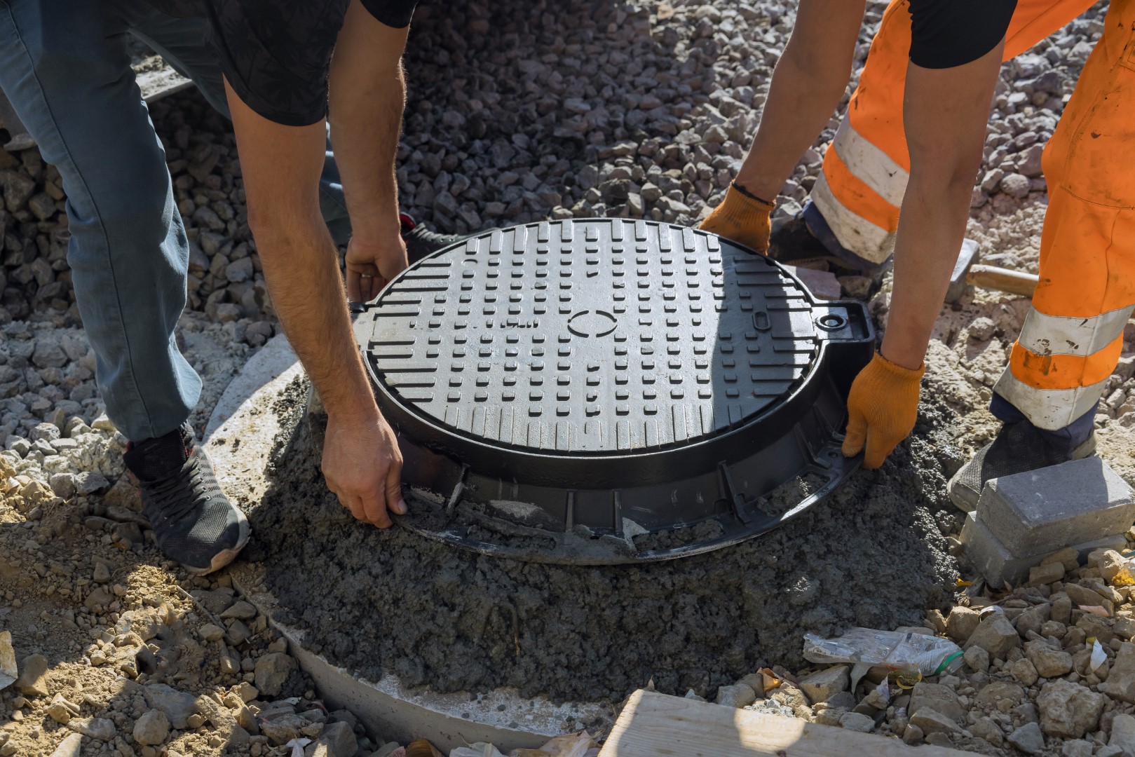 A cast iron sewer installed in concrete well, preparation for installation of water sewer well ground